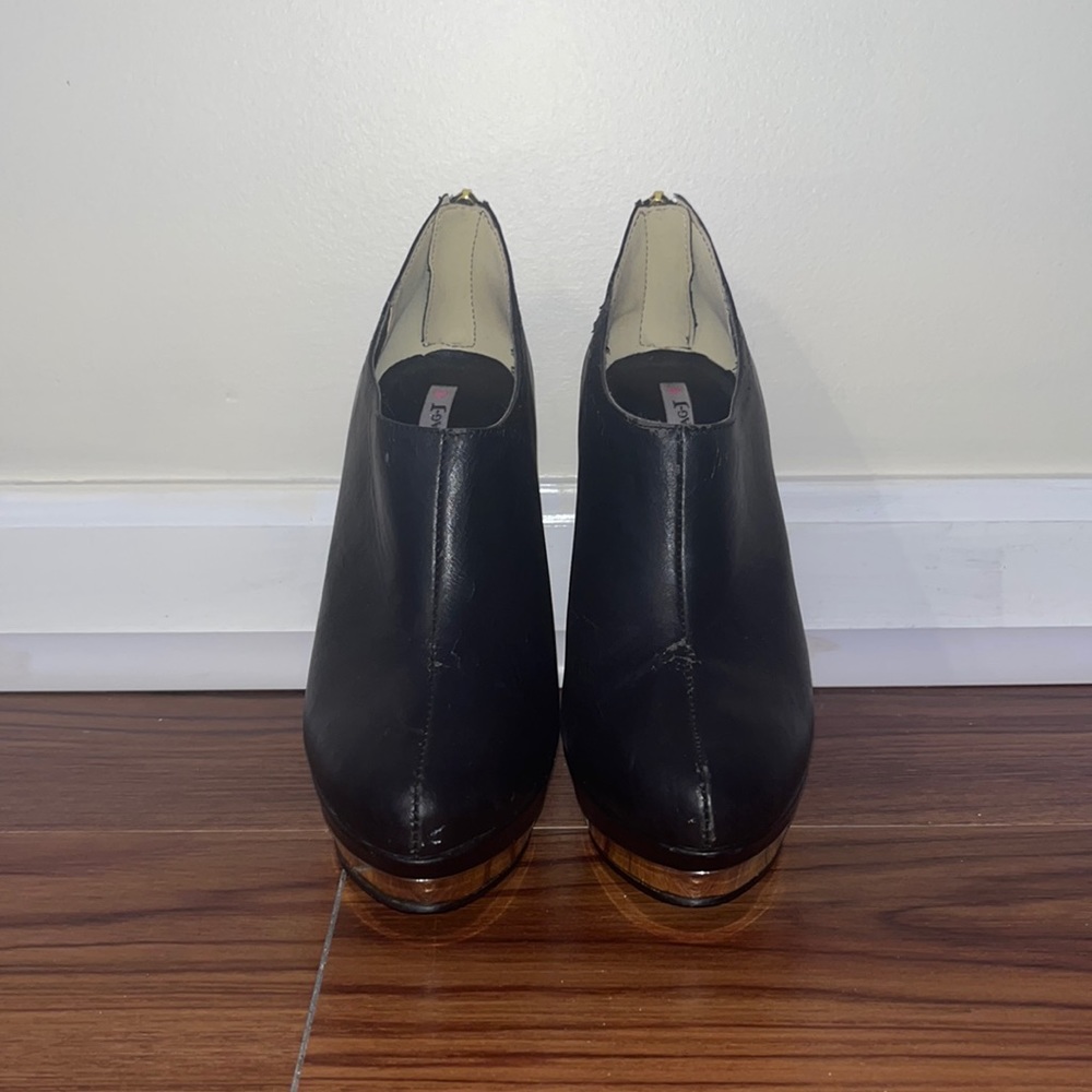 black heeled boots with gold detailing